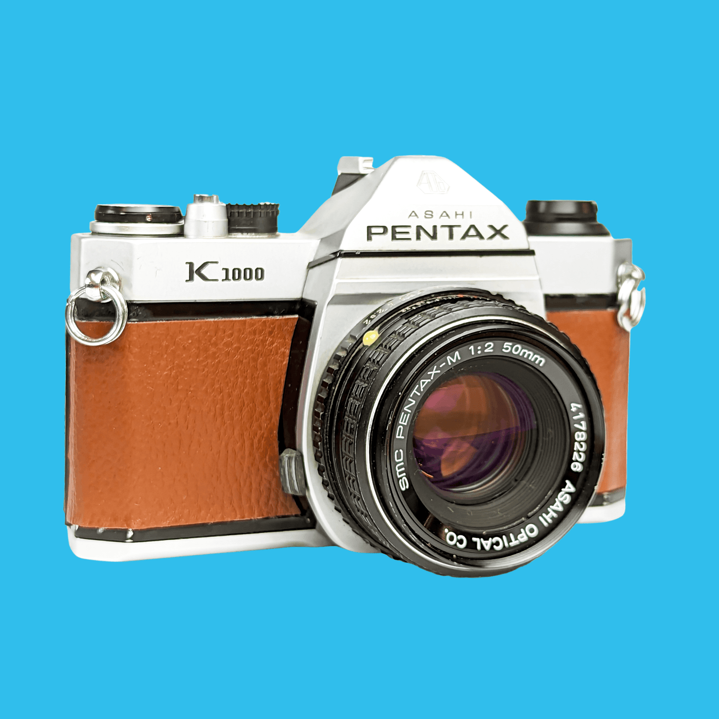 Pentax K1000 Brown Leather Vintage SLR 35mm Film Camera with Pentax f/2 50mm Prime Lens.