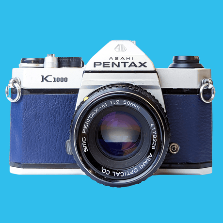 Pentax K1000 Navy Leather Vintage SLR 35mm Film Camera with Pentax f/2 50mm Prime Lens.