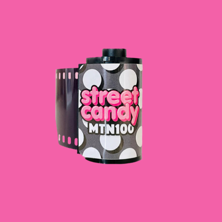 Film canister with 'street candy MTN100' text on a pink background