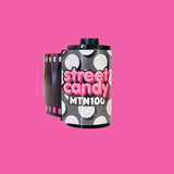 Film canister with 'street candy MTN100' text on a pink background
