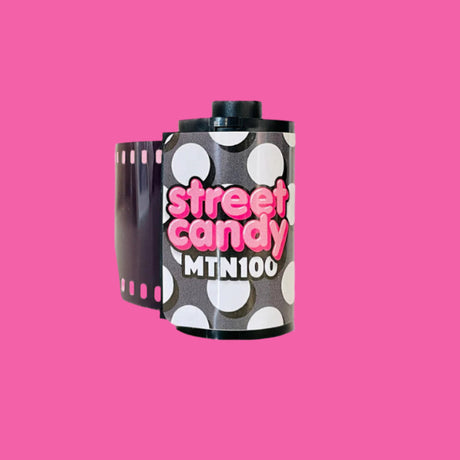 Film canister with 'street candy MTN100' text on a pink background