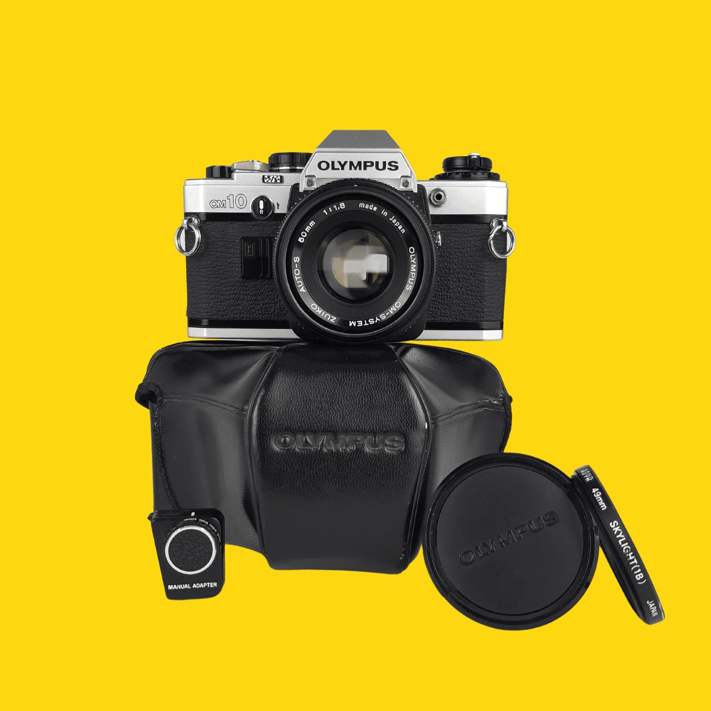 Olympus OM10 35mm SLR Film Camera w/ 50mm f/1.8 lens, Lens Cap, Leather Case & Filter