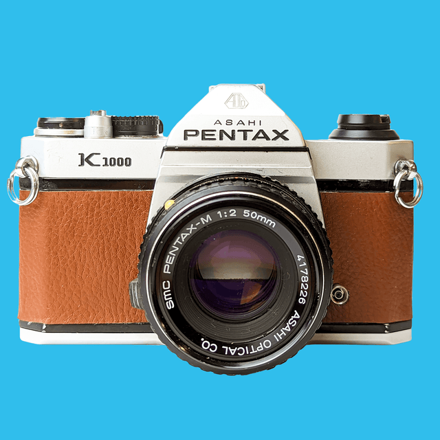 Pentax K1000 Brown Leather Vintage SLR 35mm Film Camera with Pentax f/2 50mm Prime Lens.
