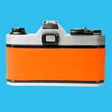 Pentax K1000 Orange Leather Vintage SLR 35mm Film Camera with Pentax f/2 50mm Prime Lens.