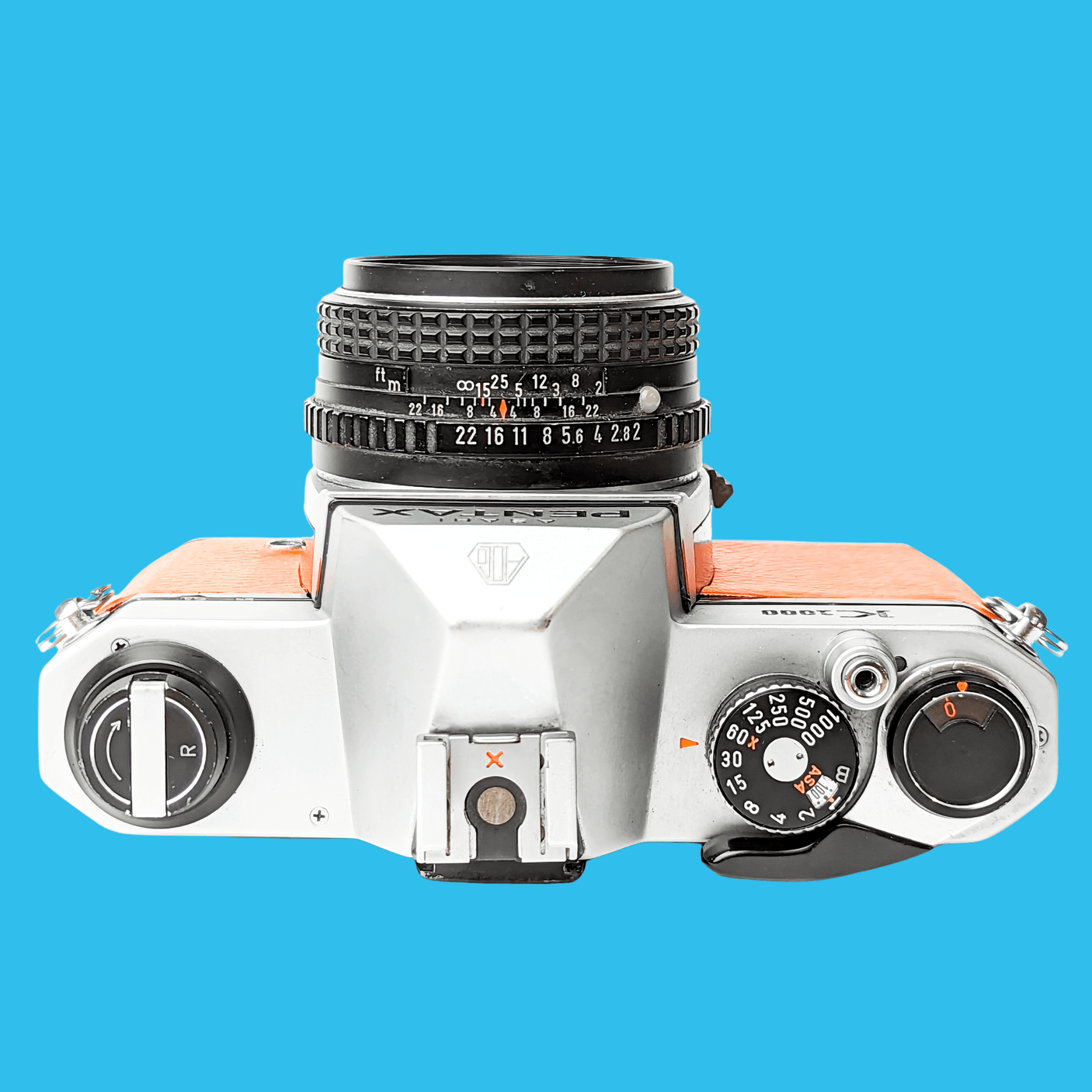Pentax K1000 Orange Leather Vintage SLR 35mm Film Camera with Pentax f/2 50mm Prime Lens.