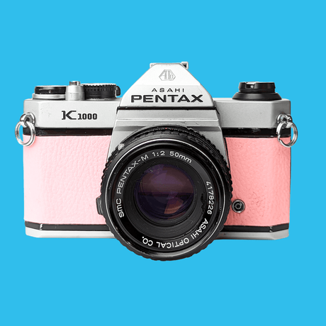 Pentax K1000 Pink Leather Vintage SLR 35mm Film Camera with Pentax f/2 50mm Prime Lens.