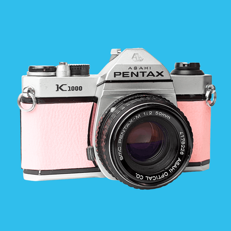 Pentax K1000 Pink Leather Vintage SLR 35mm Film Camera with Pentax f/2 50mm Prime Lens.