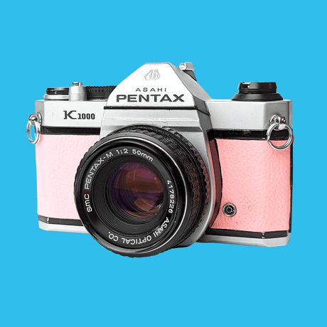 Pentax K1000 Pink Leather Vintage SLR 35mm Film Camera with Pentax f/2 50mm Prime Lens.