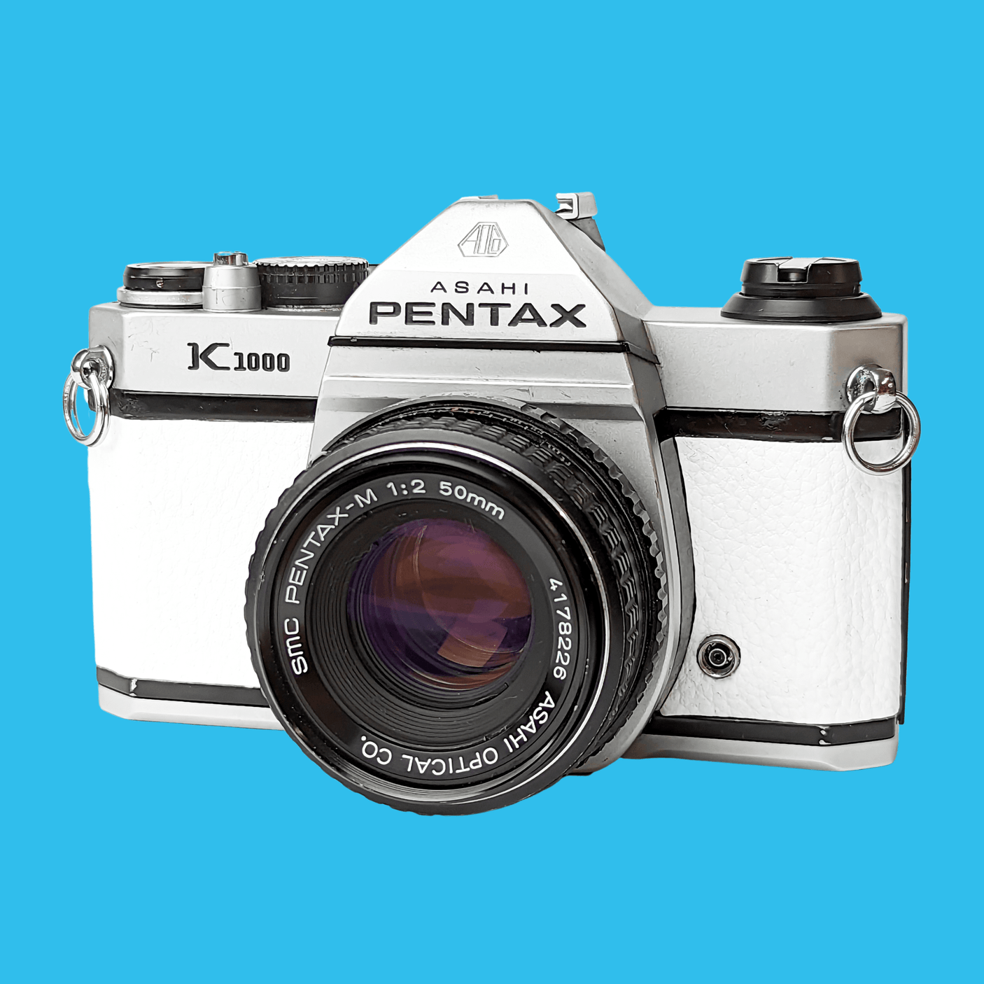 Pentax K1000 White Leather Vintage SLR 35mm Film Camera with Pentax f/2 50mm Prime Lens.