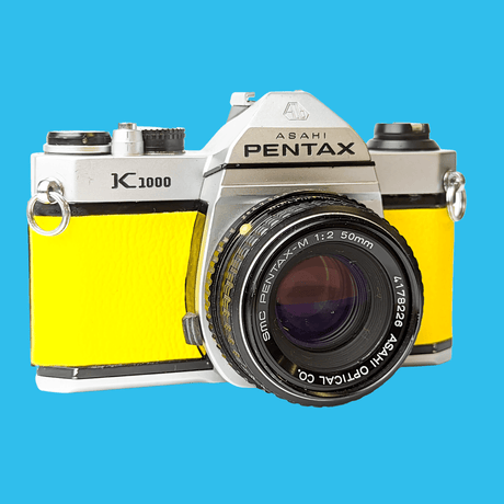 Pentax K1000 Yellow Leather Vintage SLR 35mm Film Camera with Pentax f/2 50mm Prime Lens.